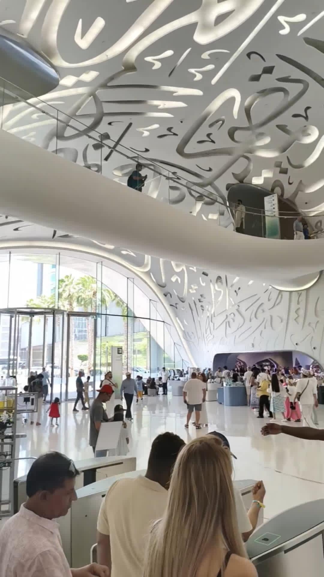Visitors exploring interactive exhibits inside the Museum of the Future Dubai, surrounded by futuristic displays and immersive 