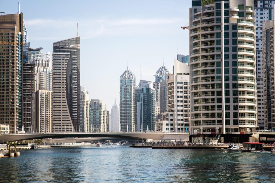 Dubai like a local: waterfront view of modern skyscrapers at sunset, capturing everyday city life and hidden charm