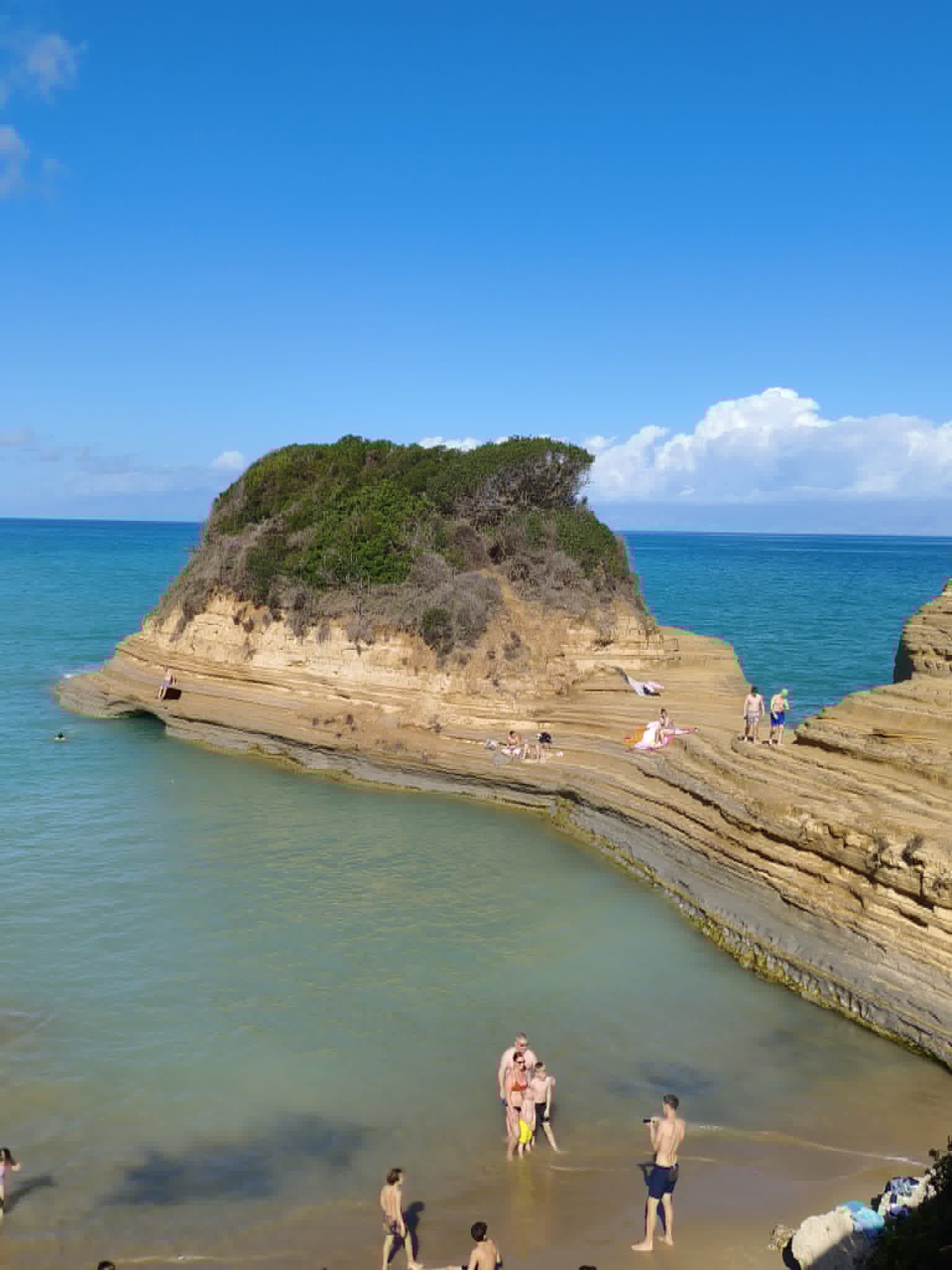 Beach day in Sidari, Corfu, with shallow water perfect for families and children.
